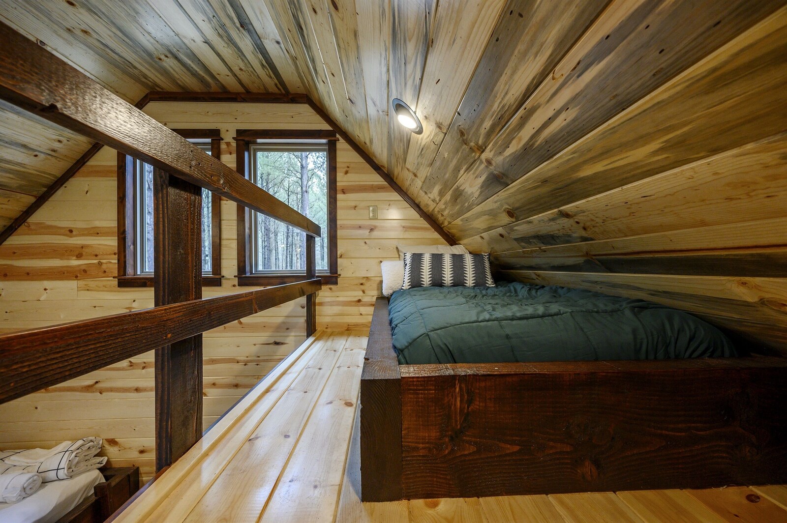 Emerald Escape bunk bed tucked under the wood ceiling