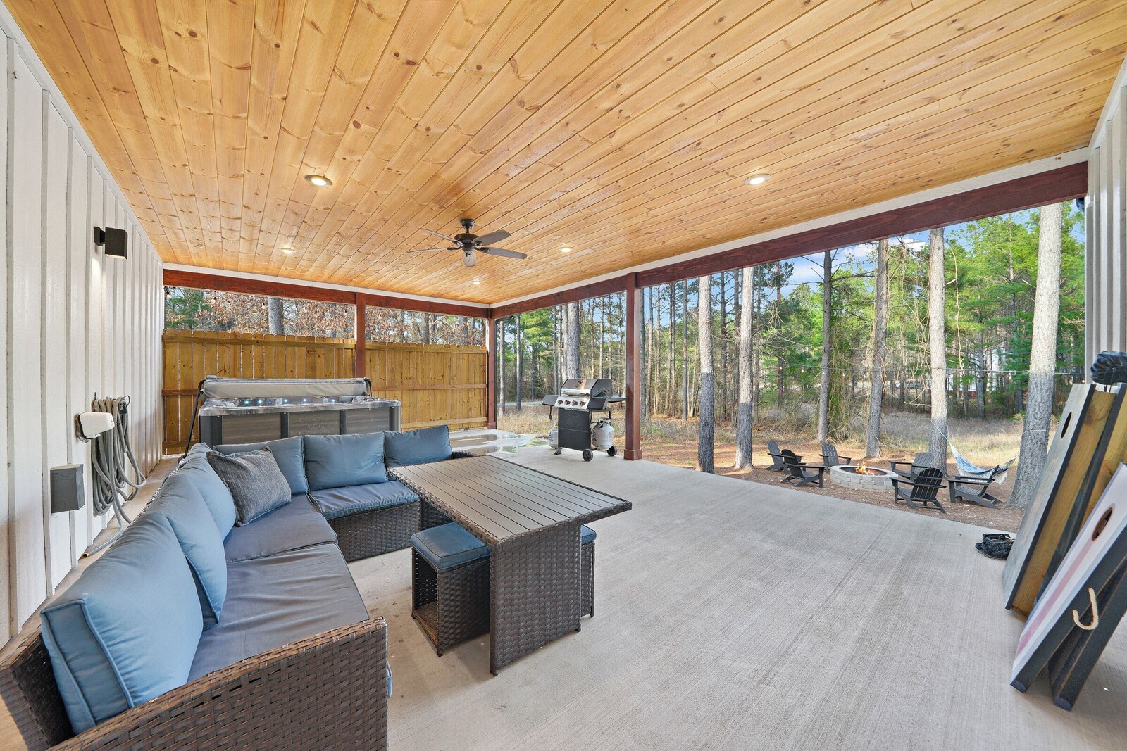 Covered patio with large dining table and built-in sofa