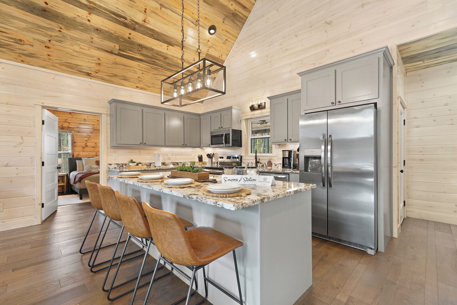 Kitchen island with bar stools and stainless steel appliances