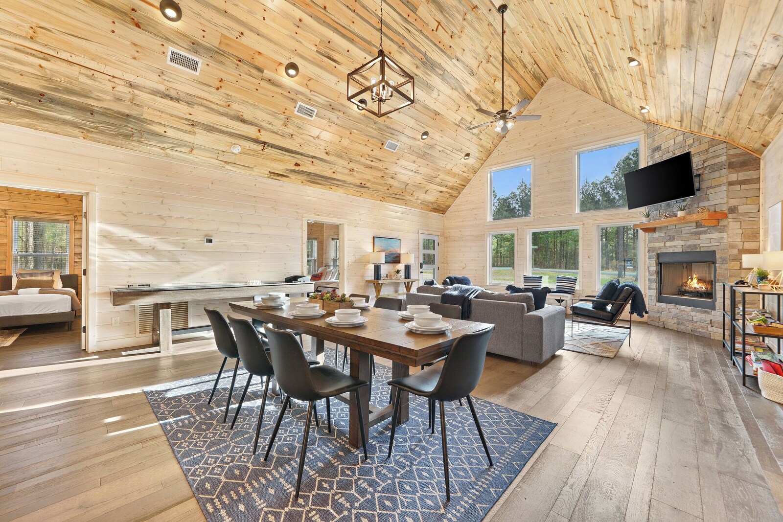 Open living area with wooden ceiling, fireplace, and large window