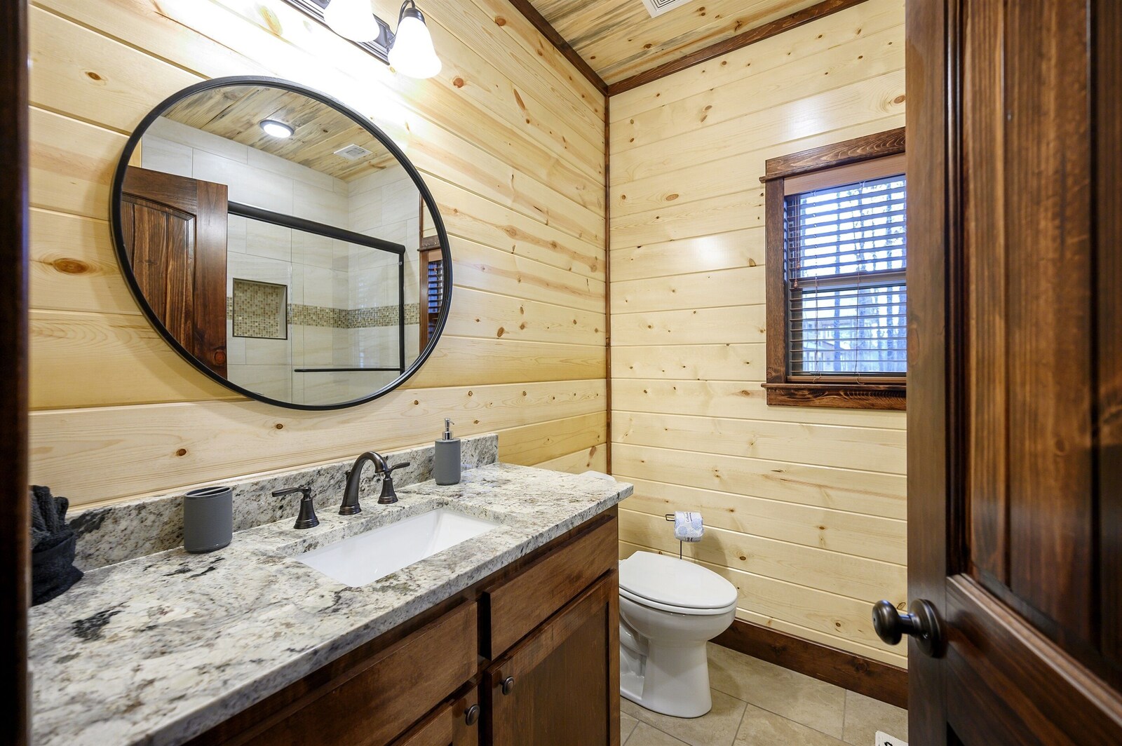 Emerald Escape bathroom with sink, mirror, and toilet