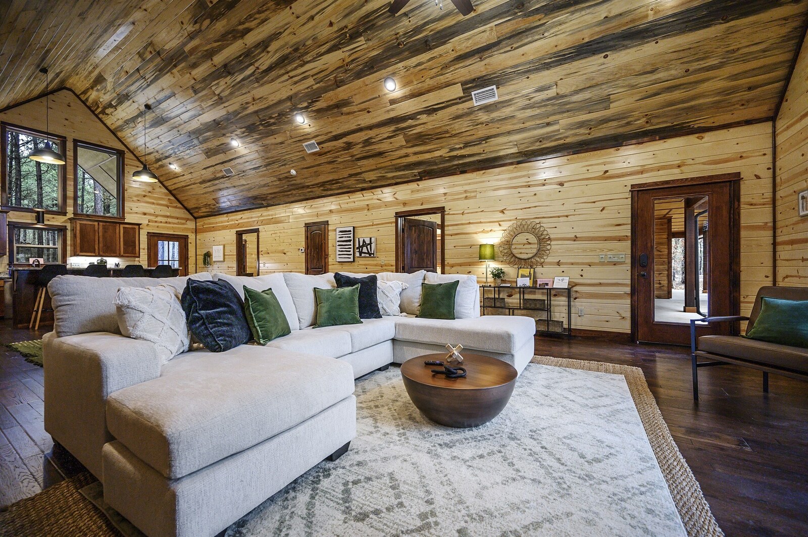 Emerald Escape living room with round coffee table and wood ceiling
