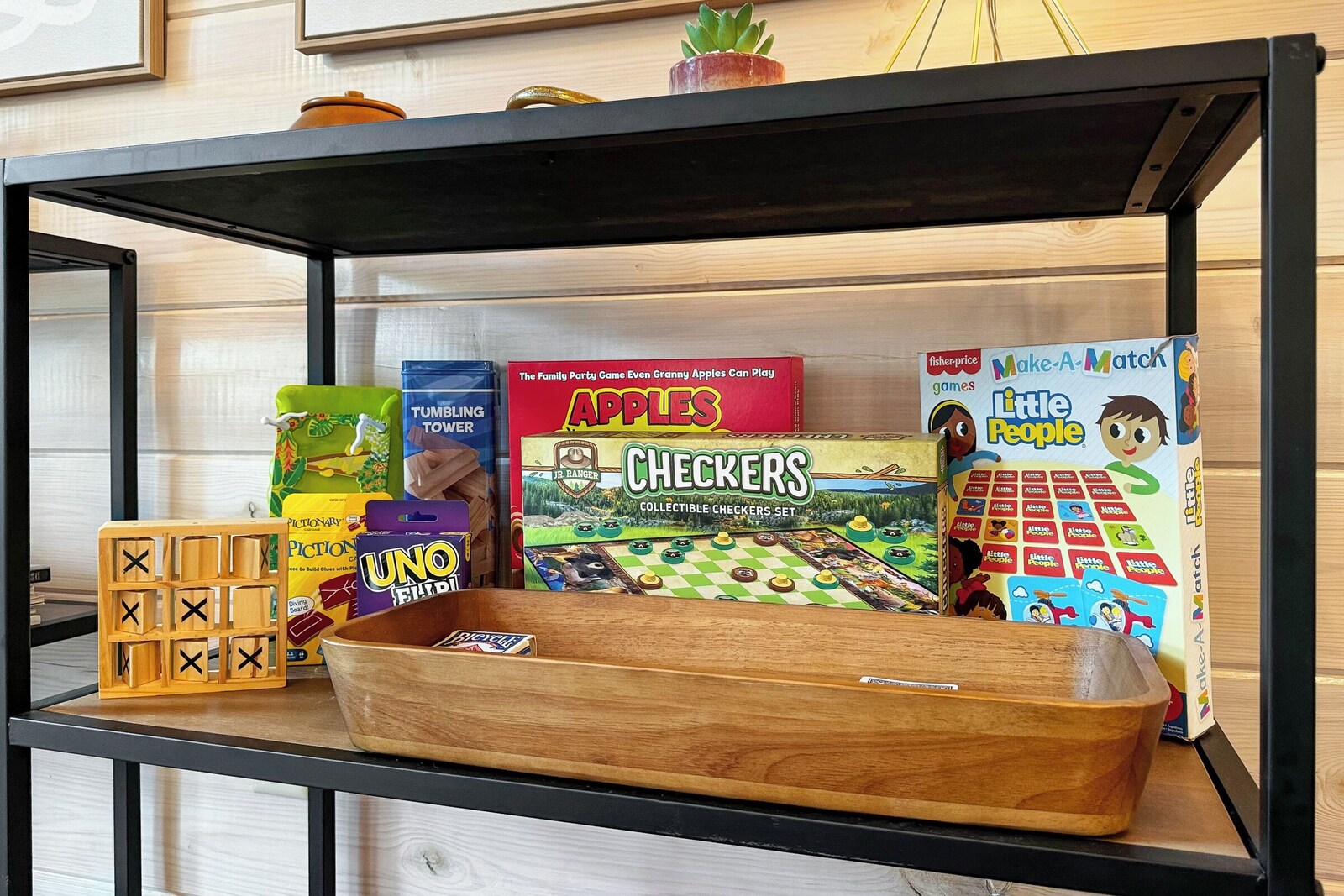 Shelf of board games including Apples, Checkers, and Uno