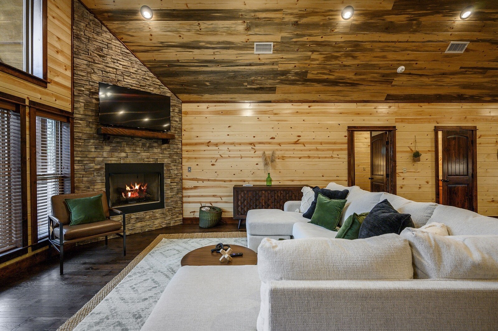 Emerald Escape living room fireplace with mounted flat-screen TV