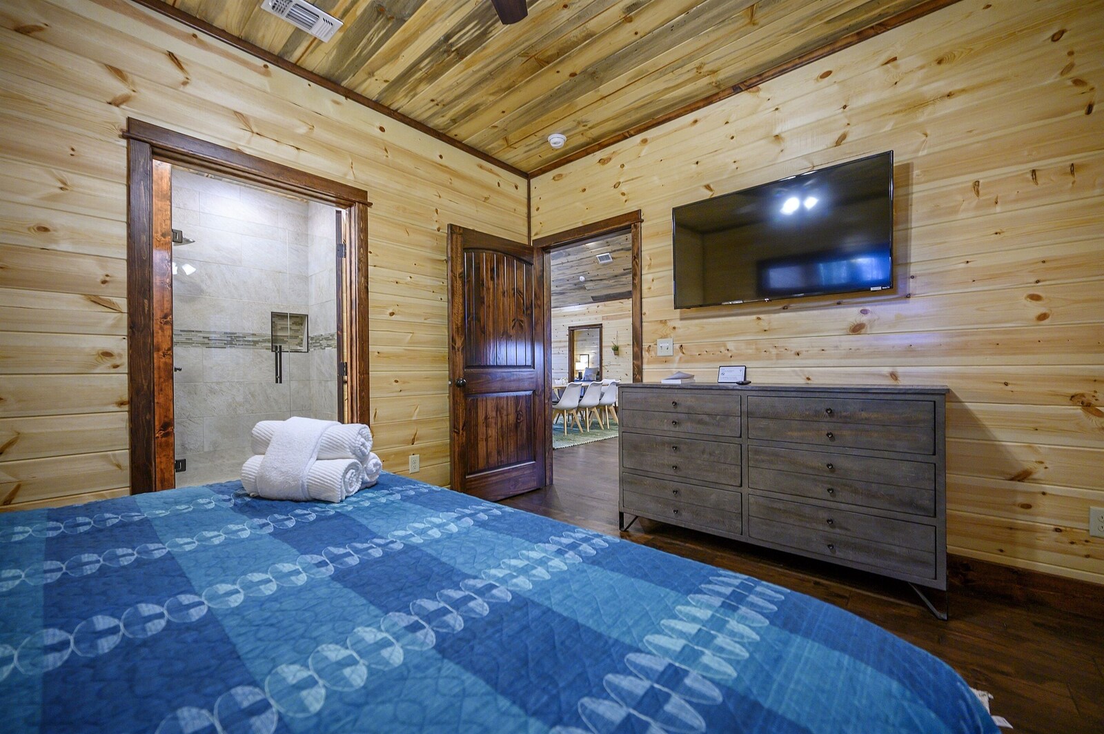 Emerald Escape bedroom with TV and dresser