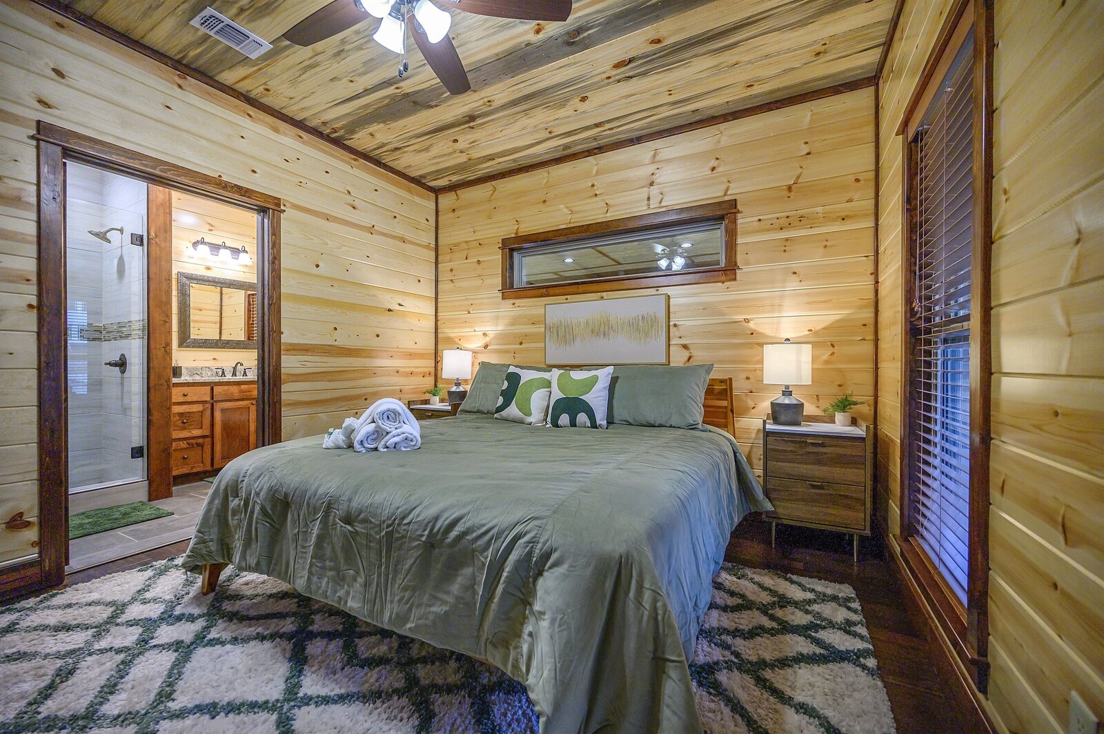 Emerald Escape bedroom with nightstand and window blinds
