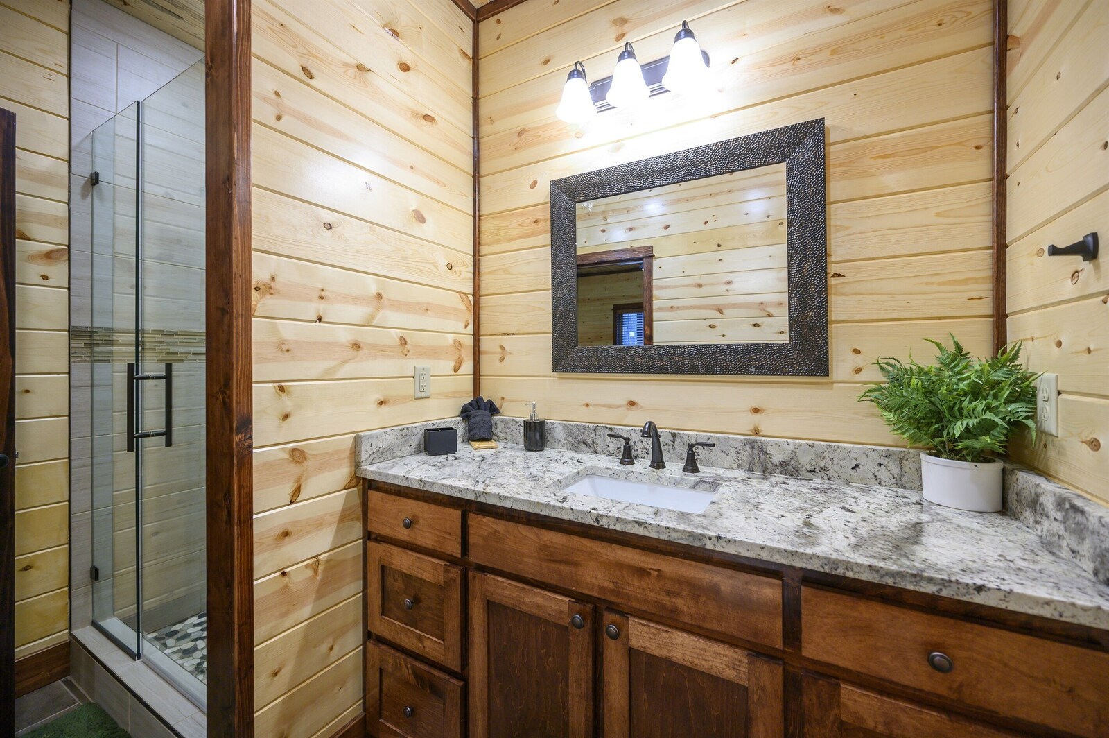 Emerald Escape ensuite bath with granite vanity and glass shower