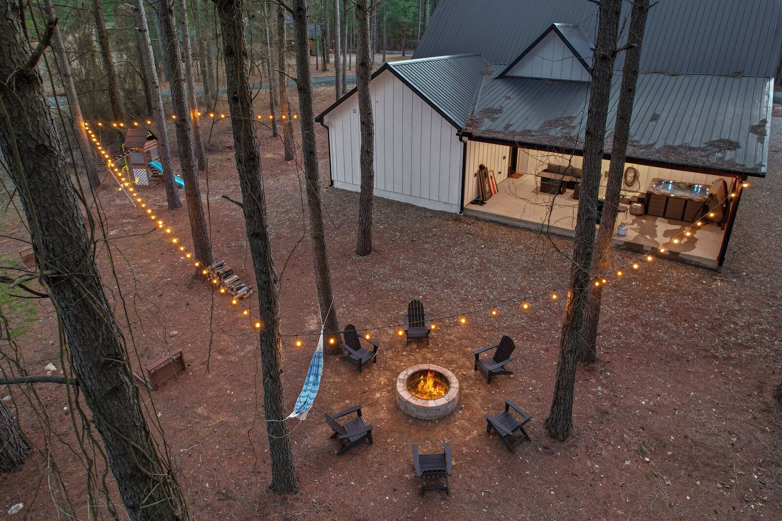Outdoor seating area with fire pit, chairs, and a shed