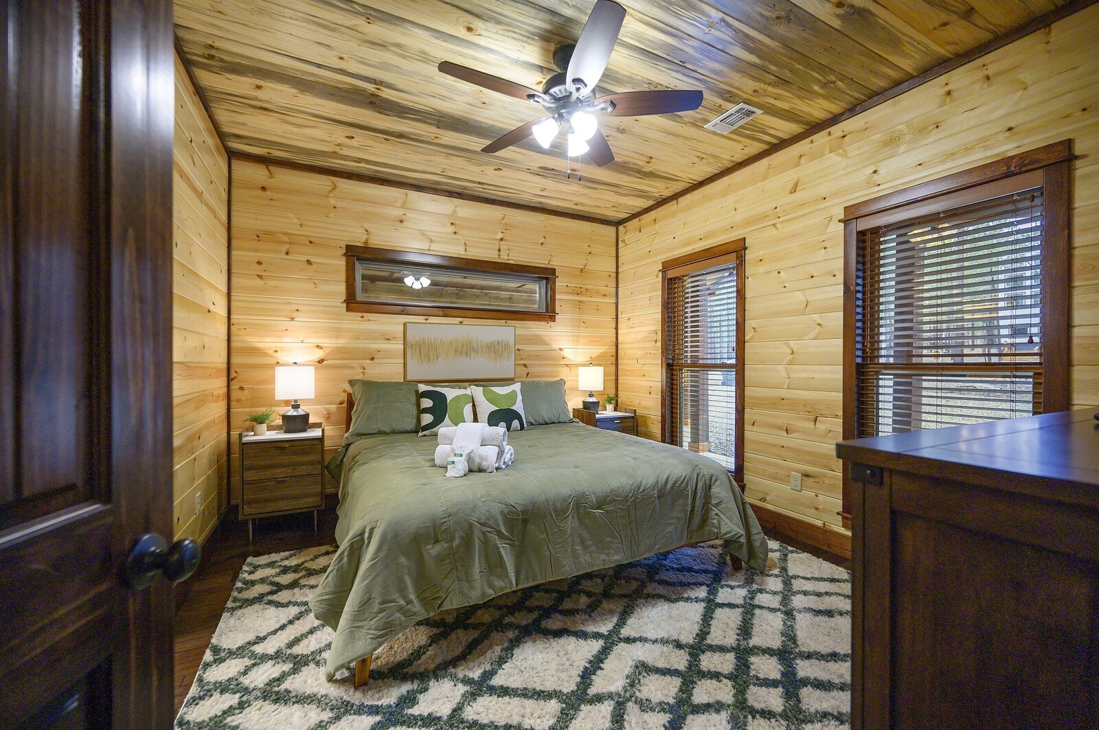 Emerald Escape bedroom with ceiling fan and king bed