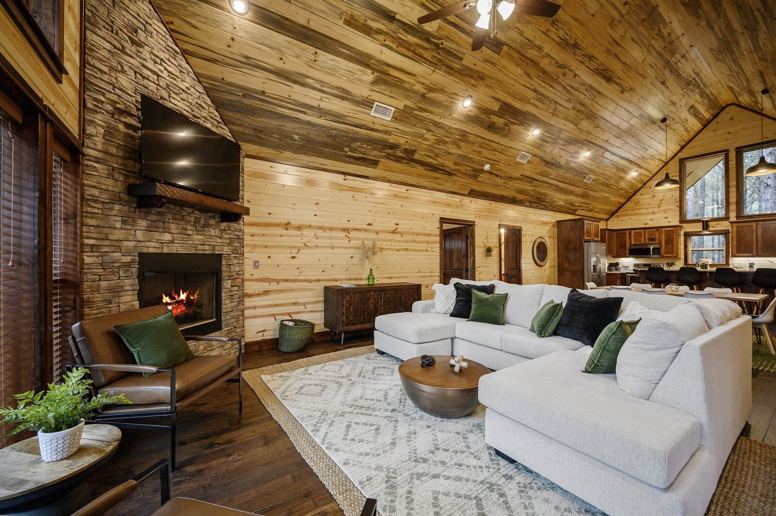 Emerald Escape living room with stone fireplace and sectional sofa