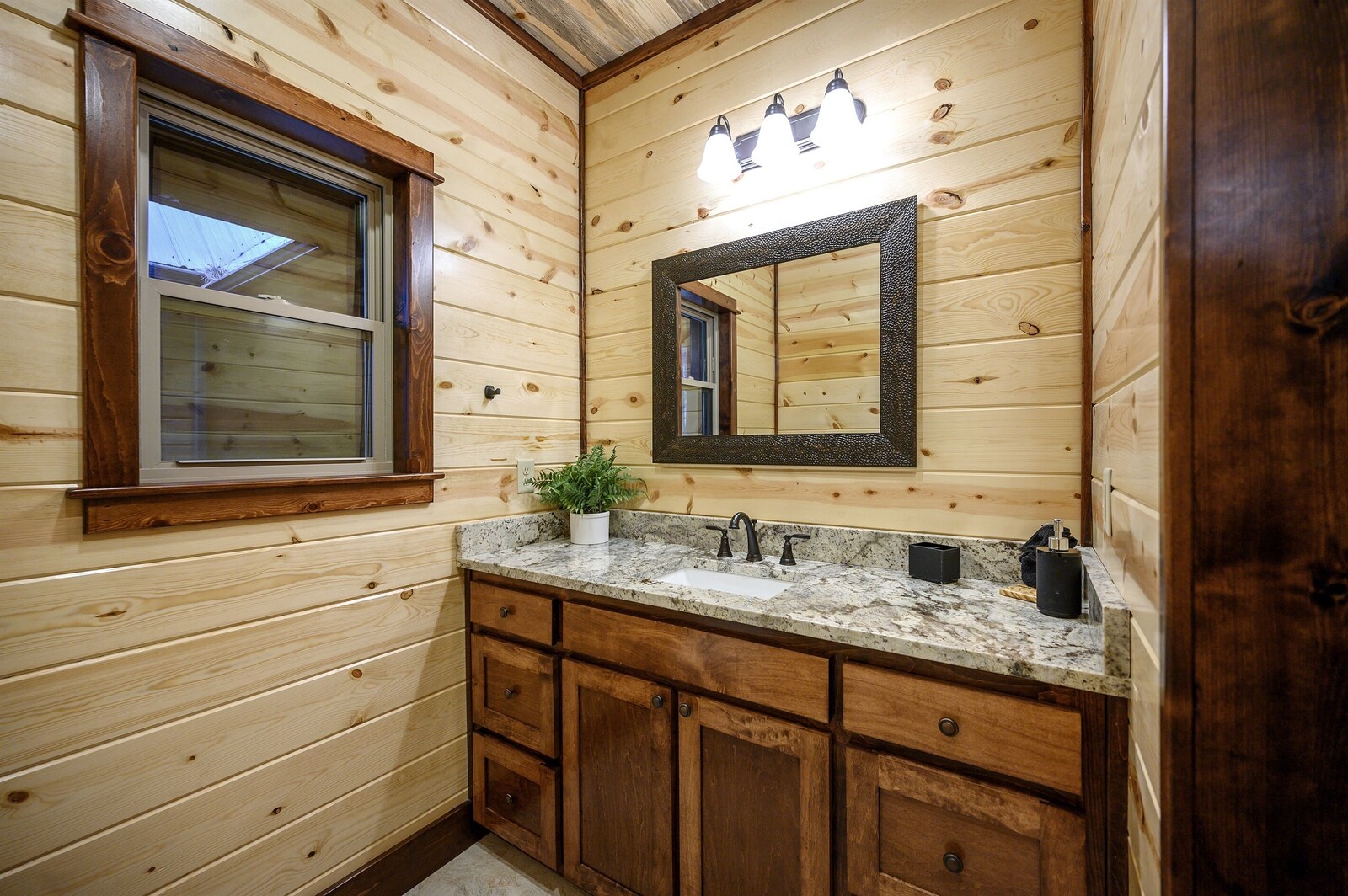 Emerald Escape bathroom with window and potted plant