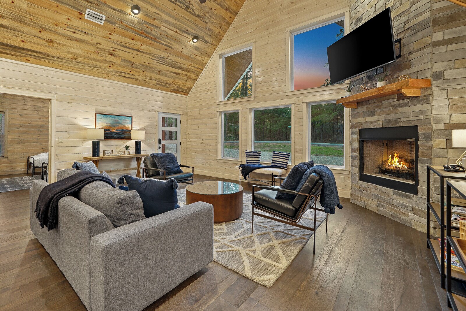 Living room with comfortable seating and tall windows