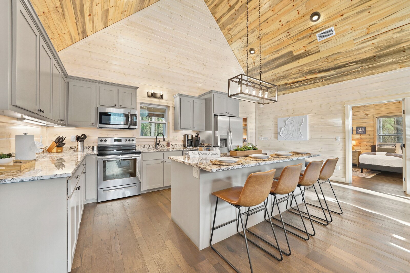 Modern kitchen with grey cabinets and a central island with bar stools
