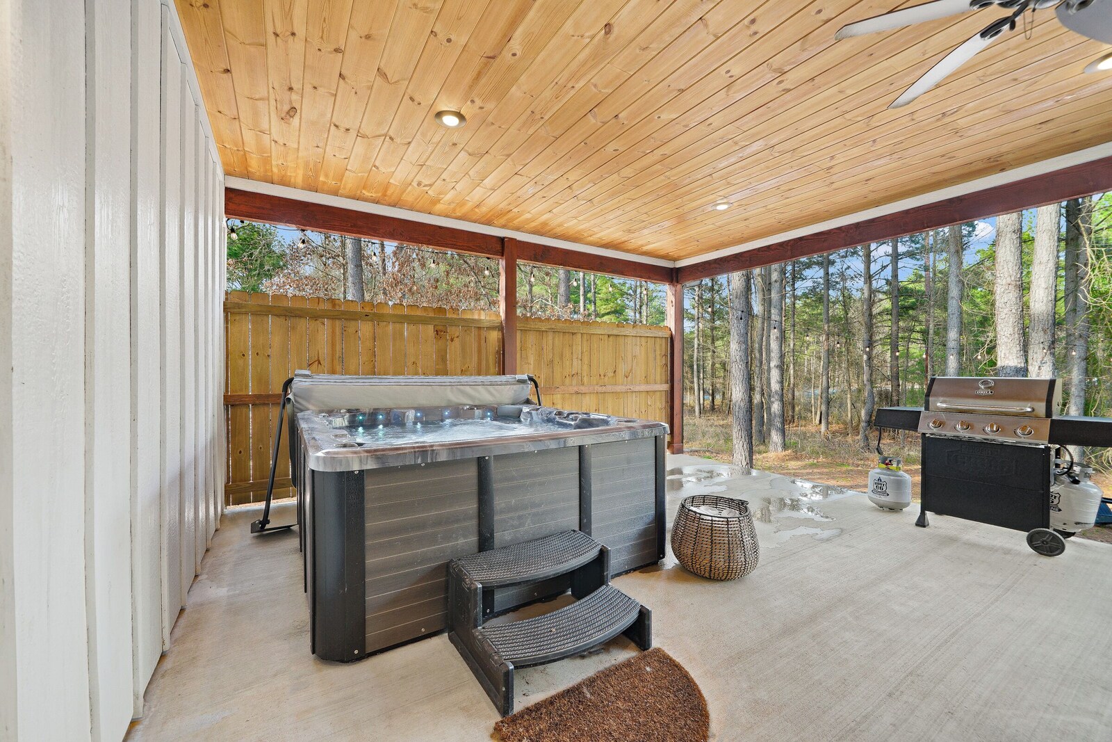 Covered deck with hot tub and grill