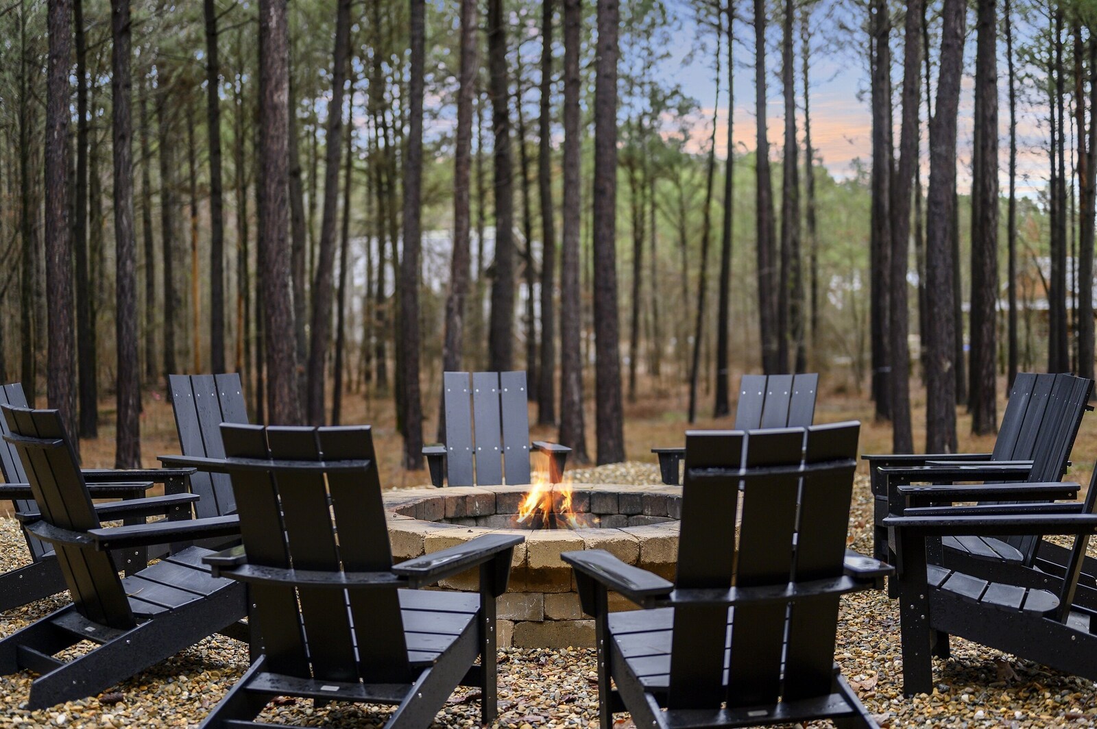 Fire pit ringed with Adirondack chairs at Emerald Escape