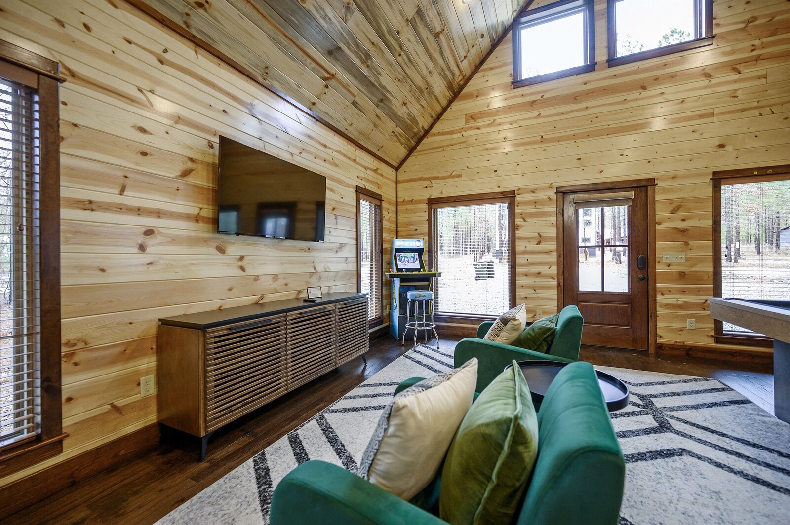Emerald Escape game room lounge with green sofa and bar