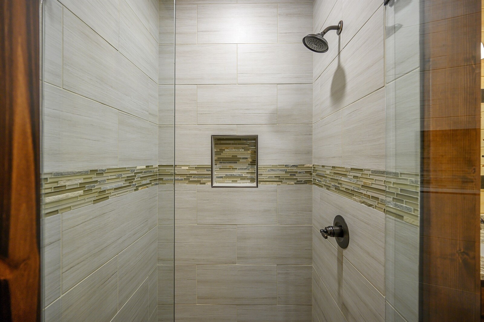 Emerald Escape glass-door shower with tile border