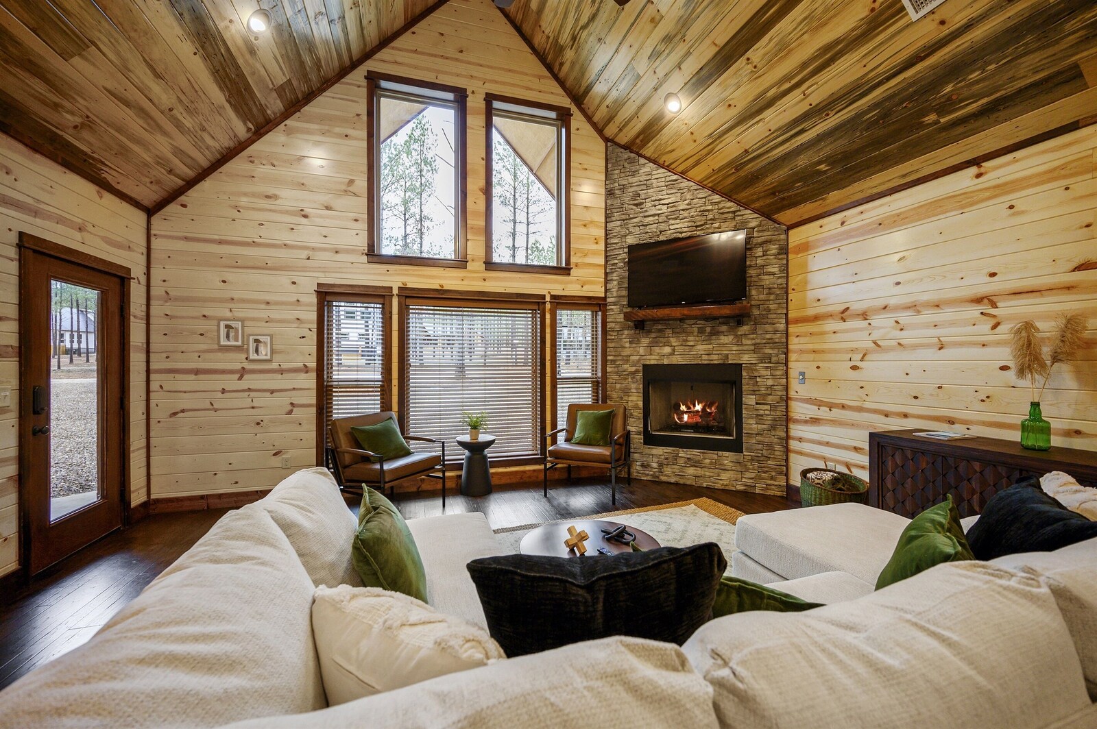 Emerald Escape living area with fireplace and large windows