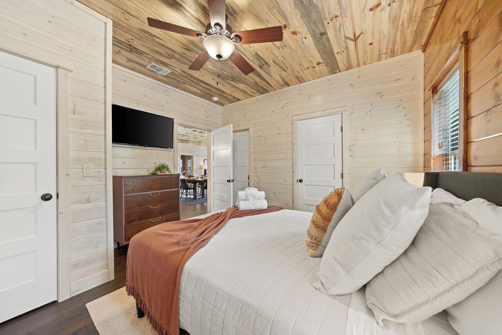 Bedroom with bed, ceiling fan, and TV